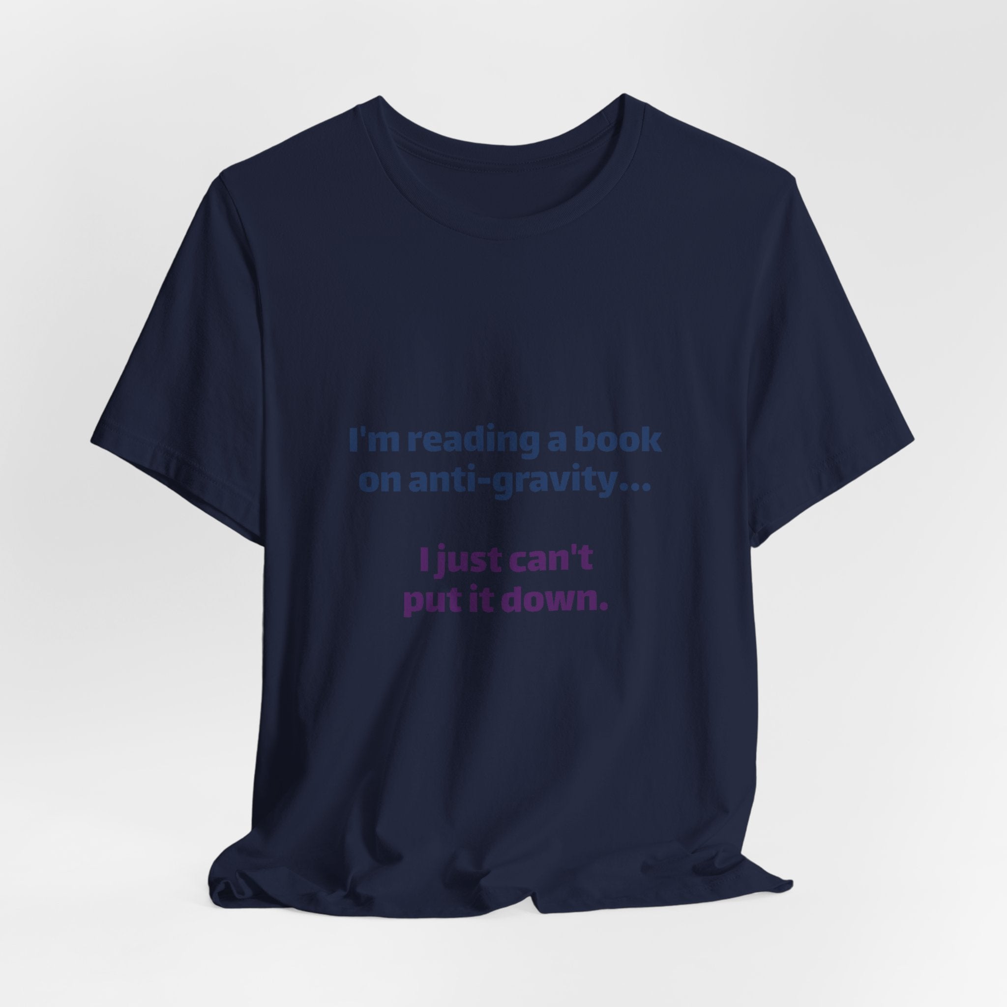 Funny Book Lover T‑Shirt — “I’m reading a book on anti-gravity… I just can’t put it down.”