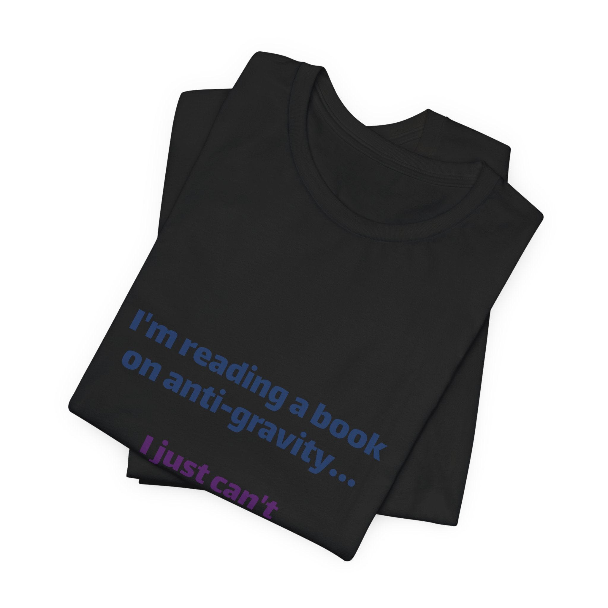 Funny Book Lover T‑Shirt — “I’m reading a book on anti-gravity… I just can’t put it down.”