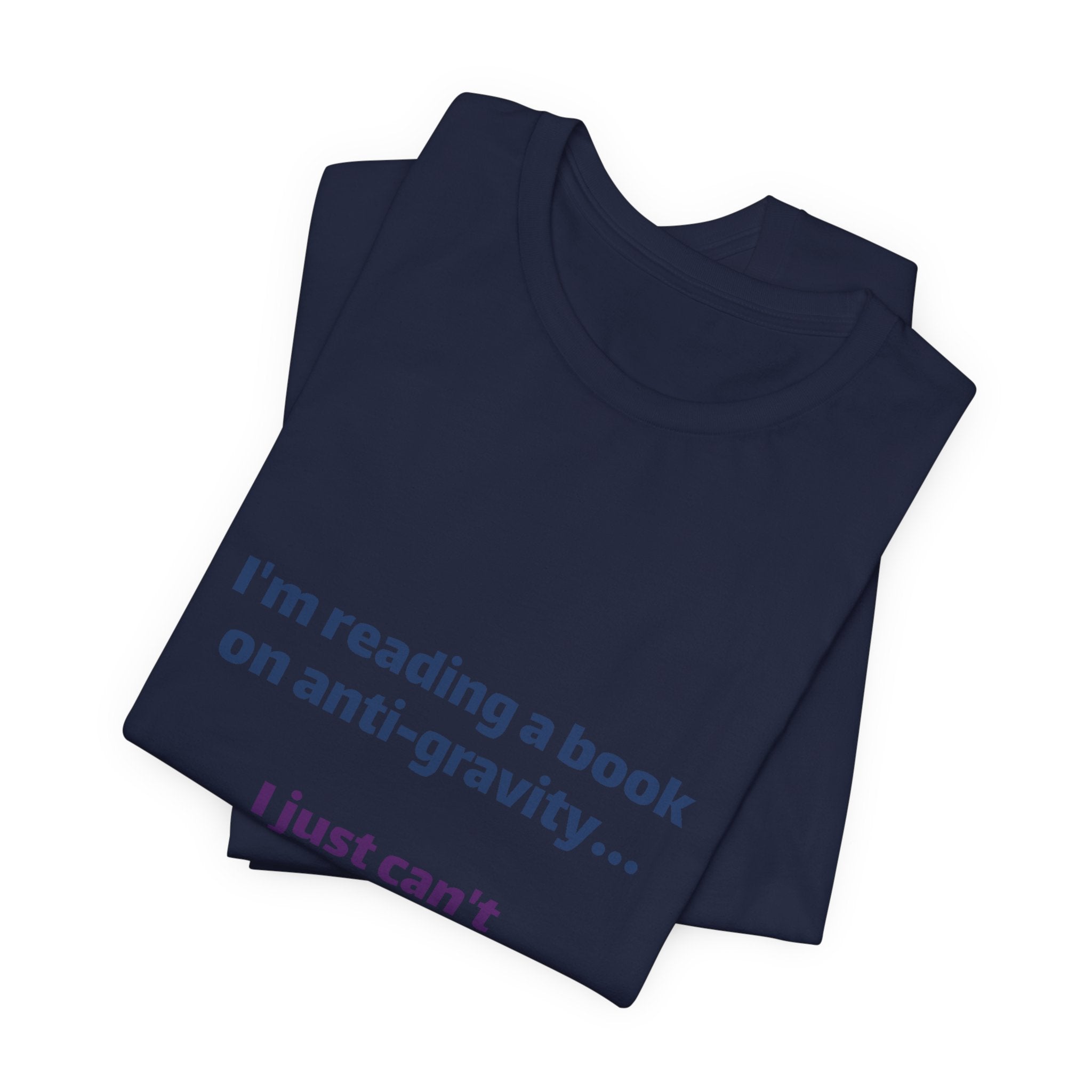 Funny Book Lover T‑Shirt — “I’m reading a book on anti-gravity… I just can’t put it down.”