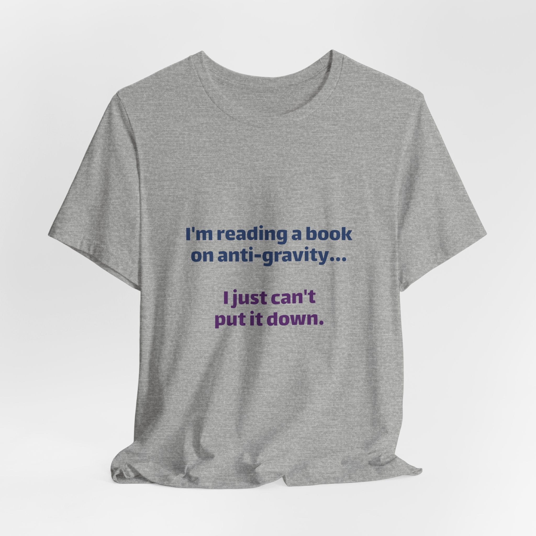 Funny Book Lover T‑Shirt — “I’m reading a book on anti-gravity… I just can’t put it down.”