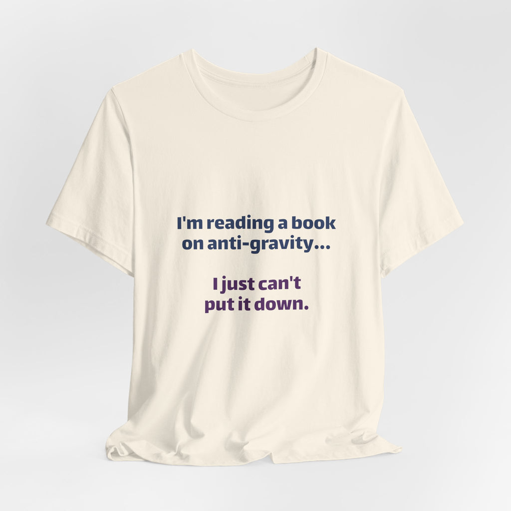 Funny Book Lover T‑Shirt — “I’m reading a book on anti-gravity… I just can’t put it down.”